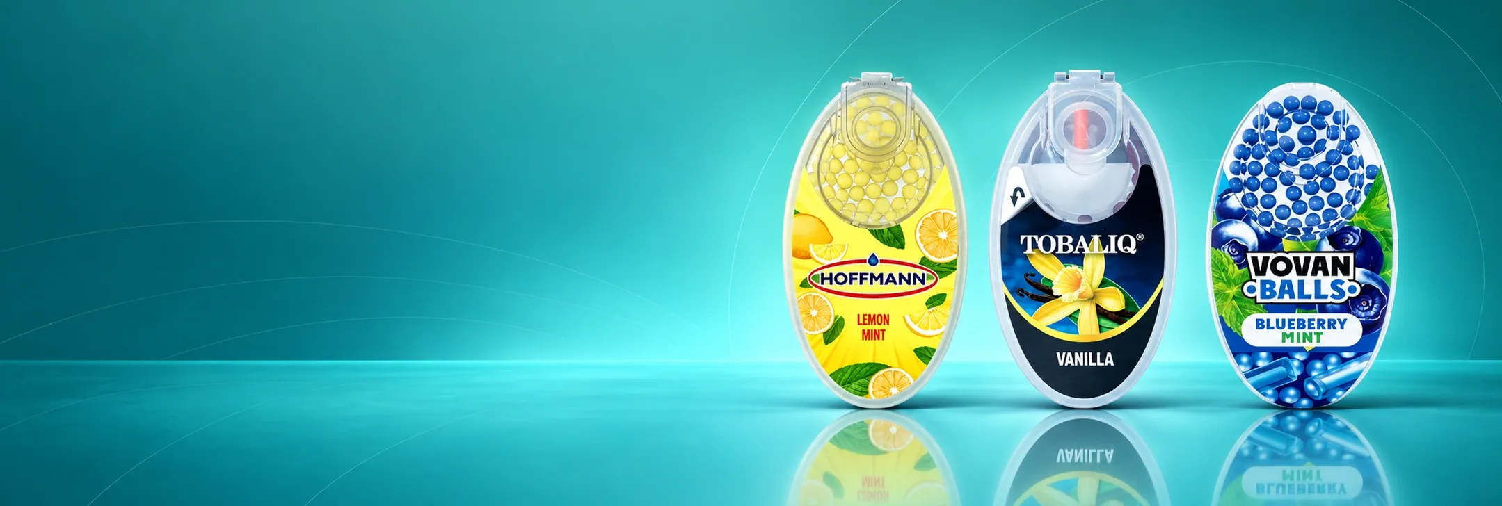 Hoffmann Lemon Mint, Tobaliq Vanille und Vovan Blueberry Mint Aromakapseln auf grünem Hintergrund