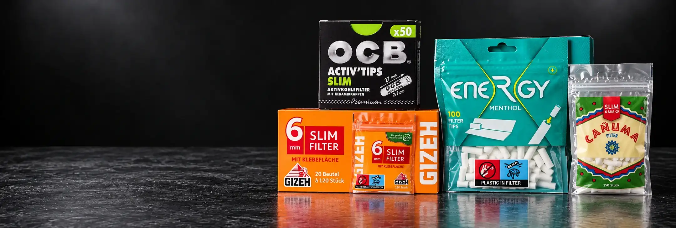 Zigarettenfilter von GIZEH, OCB, Energy+ und CANUMA auf dunklem Hintergrund