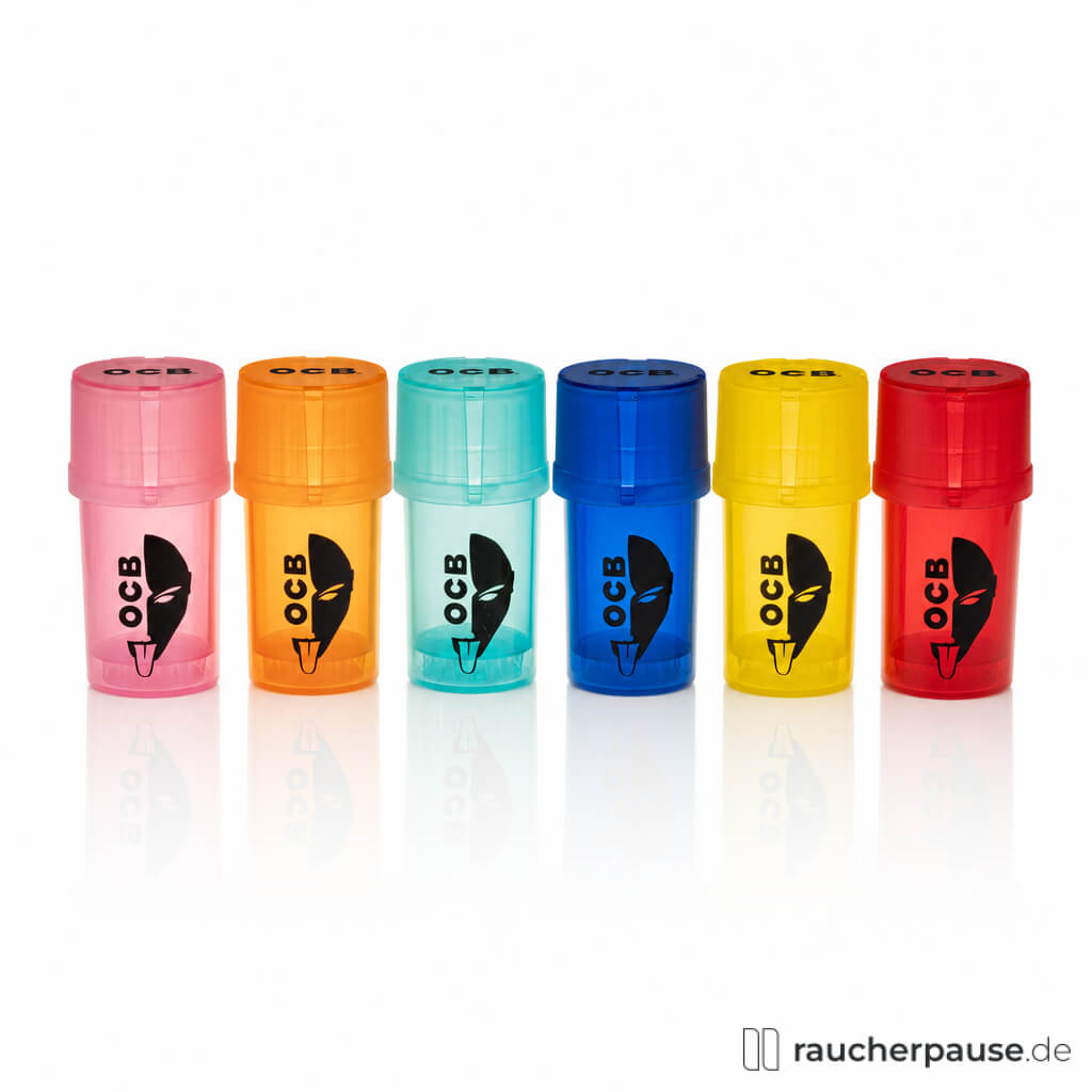 OCB Multifunctional Grinder in sechs verschiedenen Farben wie Pink, Orange, Türkis, Blau, Gelb und Rot in ovalen, transparenten Dosen mit minimalistischem Logo.